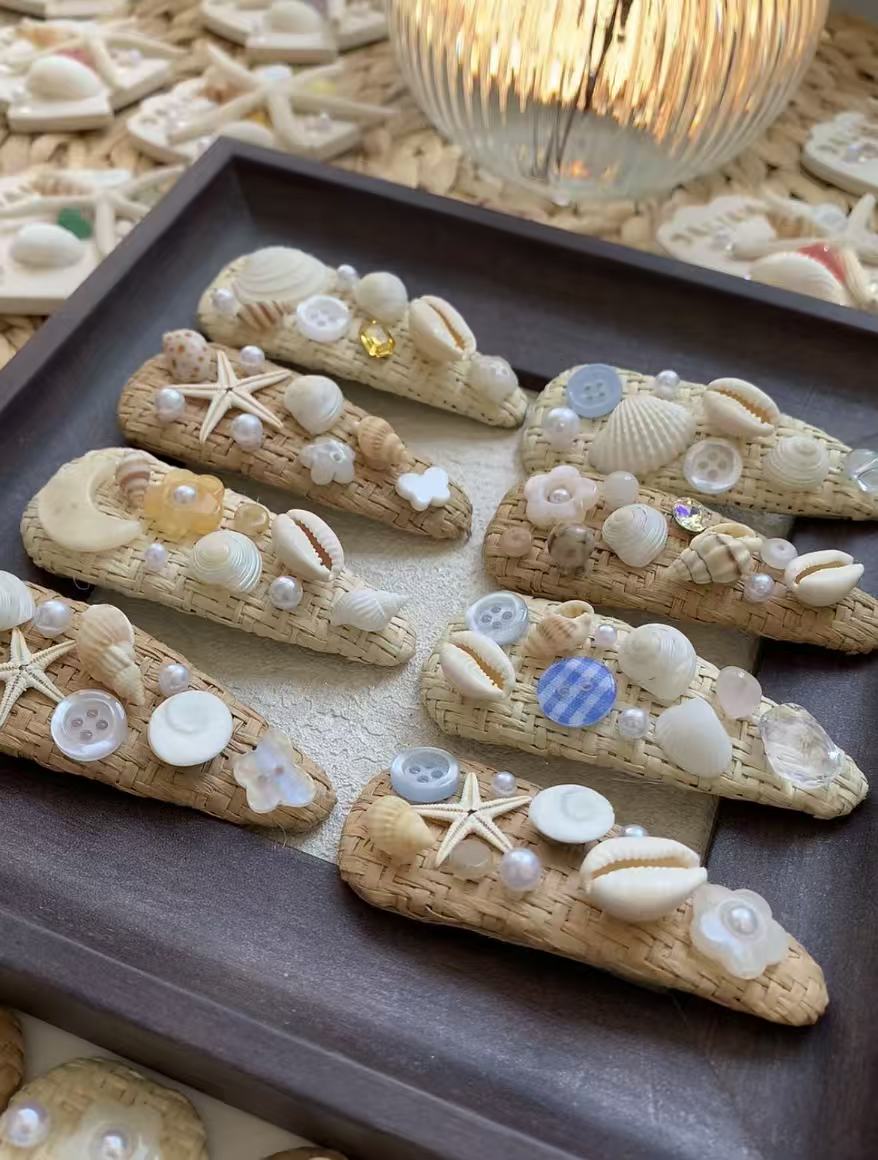A pair of shell and straw hair clips