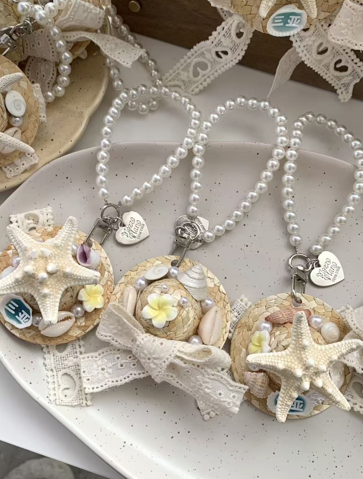 Shell and straw hat charm